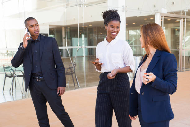 istock Positive ladies discussing project while walking over corridor 1151367929
