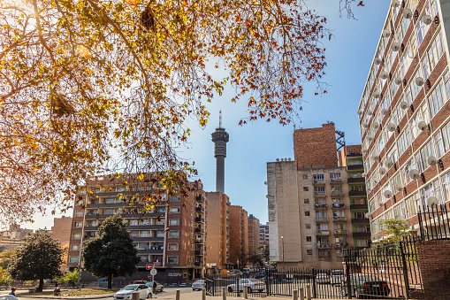 Hillbrow cityscape with the communications tower and the streets of Hillbrow, Johannesburg. Hillbrow is a densely populated residential area in Johannesburg where most of the residents are migrants from the townships, rural areas and the rest of Africa, and mostly living in real poverty.