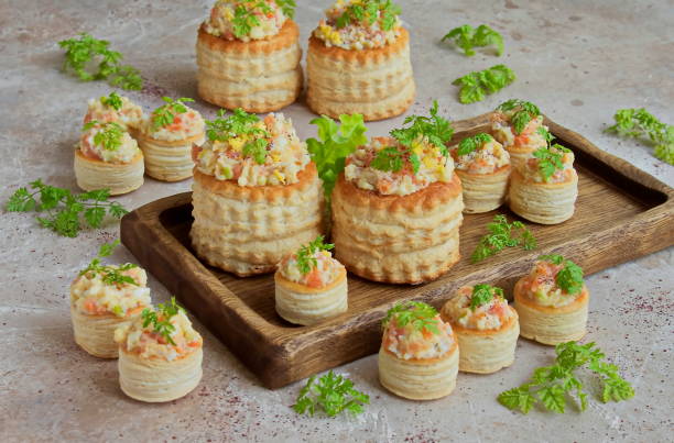 Forshmak,snack in tartlets of chopped salmon Forshmak, snack in tartlets of chopped salmon with egg and green Apple on a wooden Board for serving. Jewish cuisine kosher starter recipes stock pictures, royalty-free photos & images