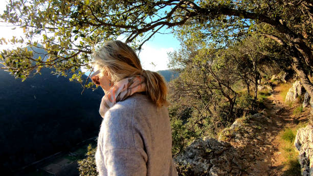 istock Mature woman hike trail sun 1151369522