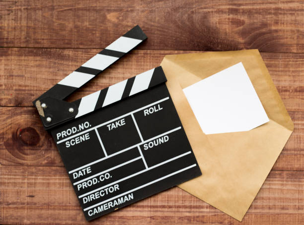 istock vintage classic clapperboard and envelope on brown wooden table 1151370247