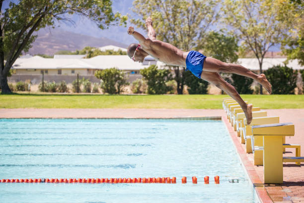 istock Male swimmer diving into a swimming pool. 1151372645