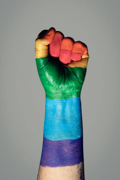 raised fist painted as a rainbow flag