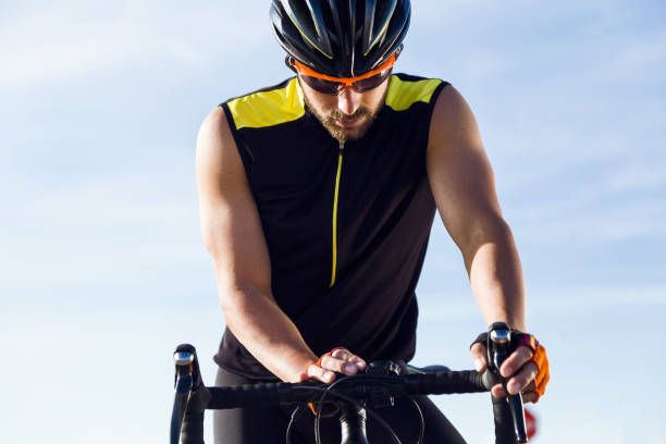 istock Young cyclist man setting timer on bicycle in sports gear. 1151375136