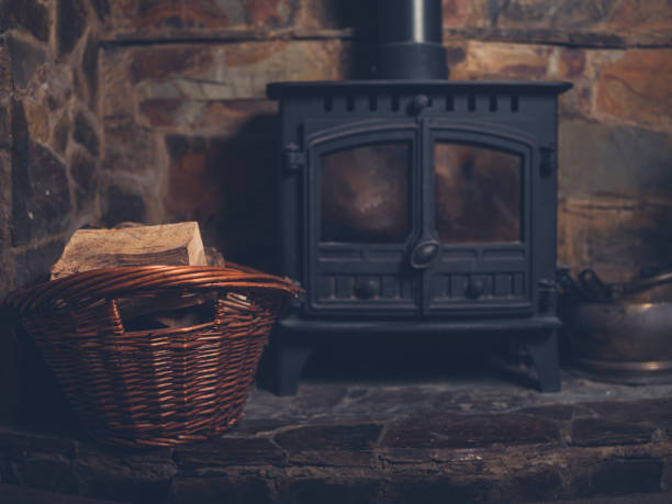 istock Log burner with basket of firewood 1151375231