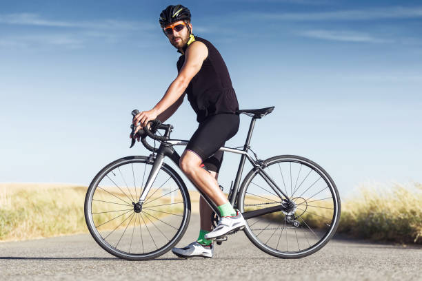 istock Handsome young man cycling on the road. 1151375321