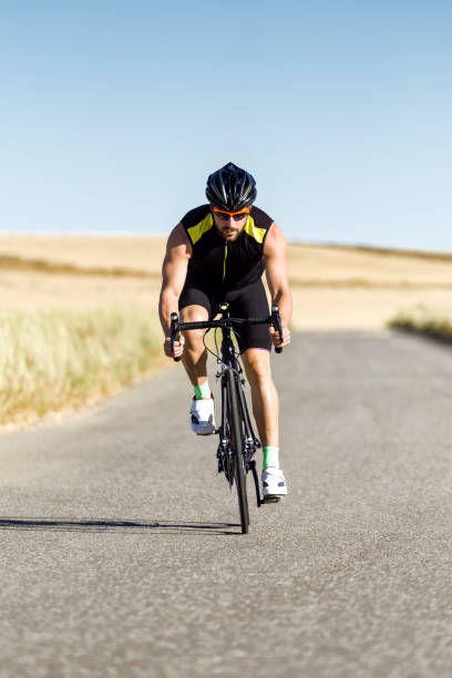 istock Handsome young man cycling on the road. 1151375360