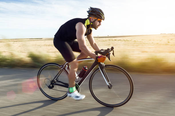 istock Handsome young man cycling on the road. 1151375369