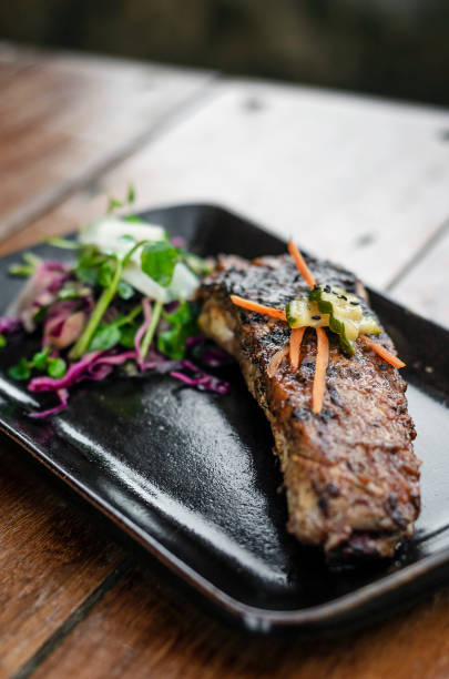 istock marinated grilled barbecue pork rib with salad and pickled vegetables 1151376349