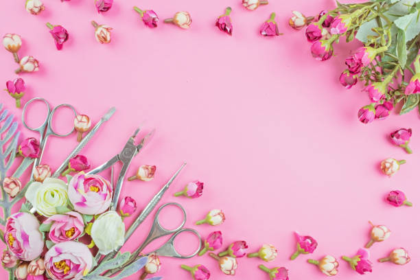 istock Manicure tools on a pink background decorated with flowers. 1151376906