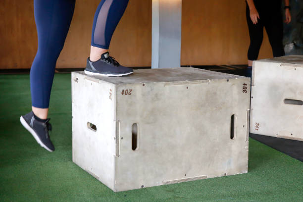 Plyometric box exercises Close up two women doing Plyometric box exercises sportsman professional sport side view horizontal stock pictures, royalty-free photos & images