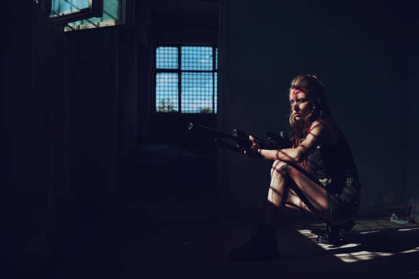 serios and focused soldier woman with her gun waiting.