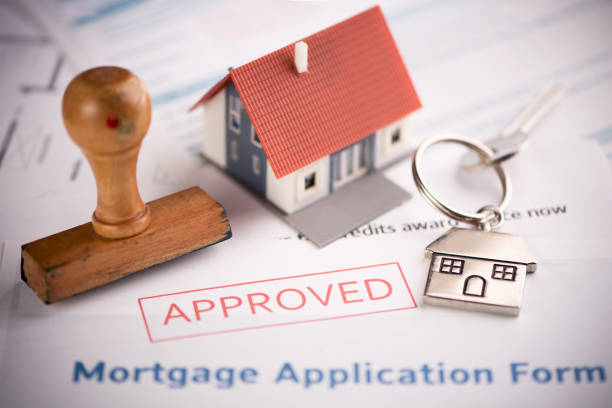 istock An approved Mortgage loan application form with house key and rubber stamp 1151380454