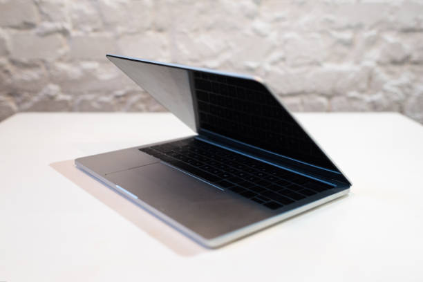 istock Modern laptop with blank screen on white table in cafe 1151381470
