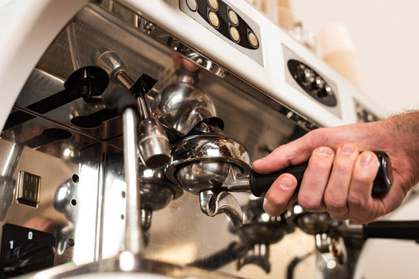 istock Cropped view of barista using coffee machine in cafe 1151381507
