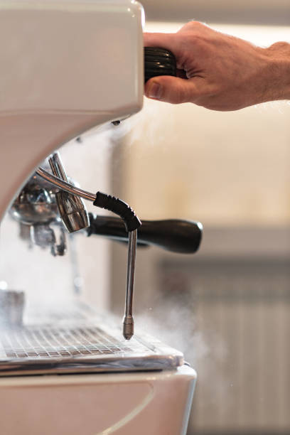 istock Cropped view of barista using coffee machine in cafe 1151381511