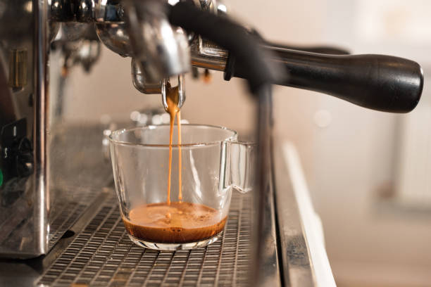 istock Selective focus of coffee machine and glass cup with coffee 1151381527