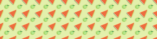 istock panoramic shot of seamless pattern with handmade cardboard apples and watermelon slices isolated on green 1151381733