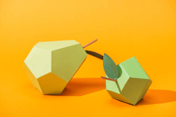 istock handmade paper pear and apple on orange with copy space 1151381930