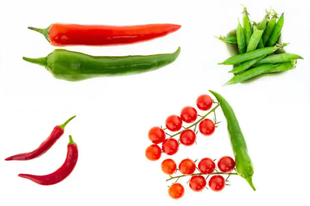 set of hot peppers large pod parallel green green chile set peas pod branch of cherry tomatoes culinary collage on white background