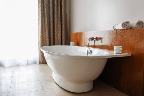 istock Stylish snow-white bathtab in a modern bathroom. Contemporary bathroom interior. Luxury lifestyle 1151383068