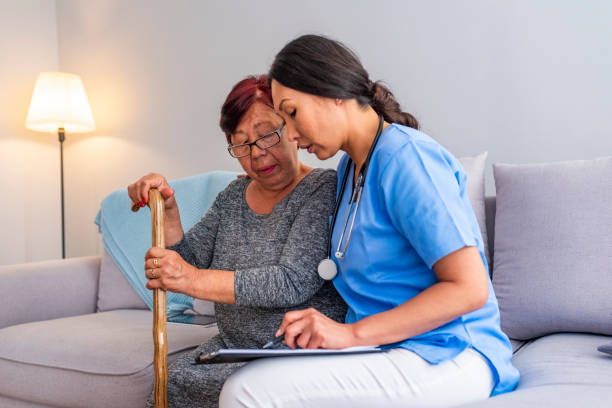 istock Nurse talking with elderly woman in light room. 1151384216