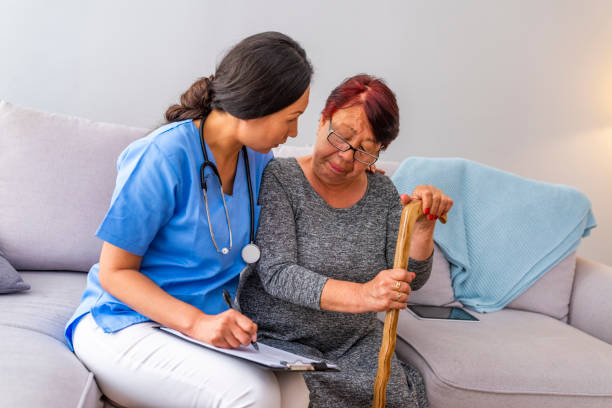 istock Nurse talking with elderly woman in light room. 1151384831