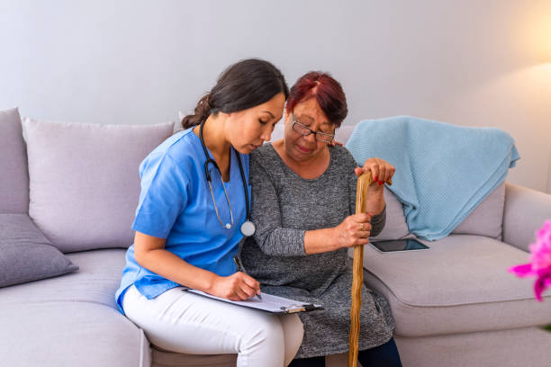 istock Young carer supporting senior disabled woman with walking stick 1151386508