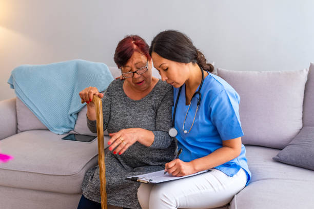istock Happy patient is holding caregiver for a hand while spending time together. 1151386509