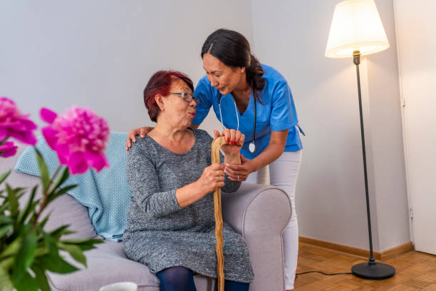 istock Nurse talking with elderly woman in light room 1151387876