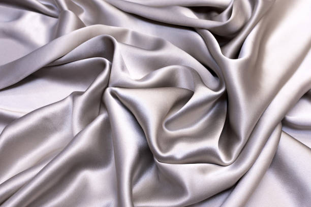 istock Silk satin fabric in light gray with artistic layout 1151388151