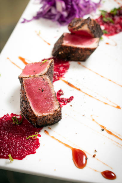 istock gourmet seared tuna in black pepper crust with beetroot and raspberry coulis 1151388359