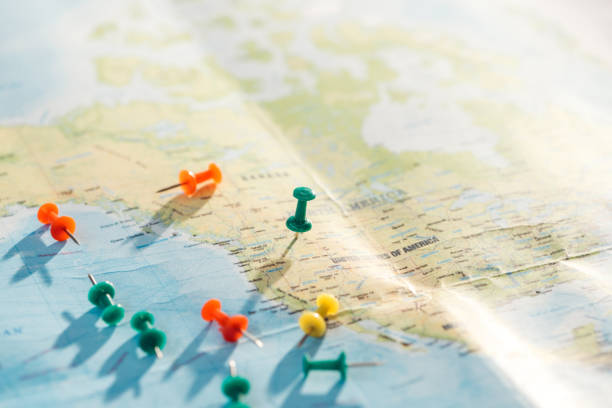 istock selective focus of world map with colorful push pins 1151398854
