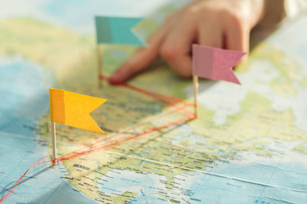 istock Partial view of kid with colorful flags on world map 1151398899