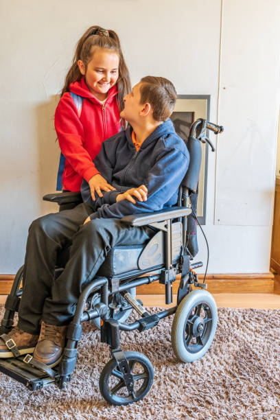 istock Young carer with boy in wheelchair 1151398909