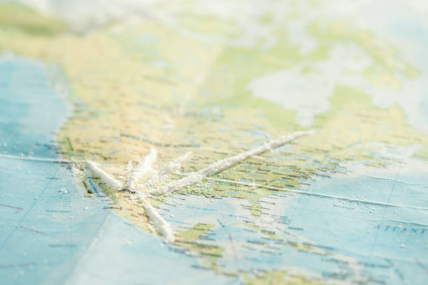 istock Selective focus of cocaine on colorful world map 1151398910