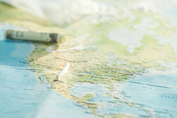 istock Selective focus of cocaine and dollar banknote on world map 1151398912