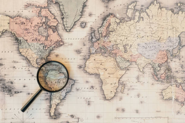 istock Top view of magnifying glass on world map 1151398924