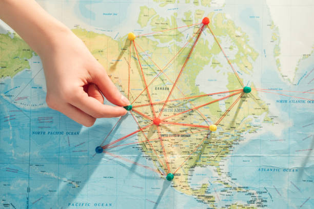 istock Partial view of woman with push pins, strings and world map 1151398970