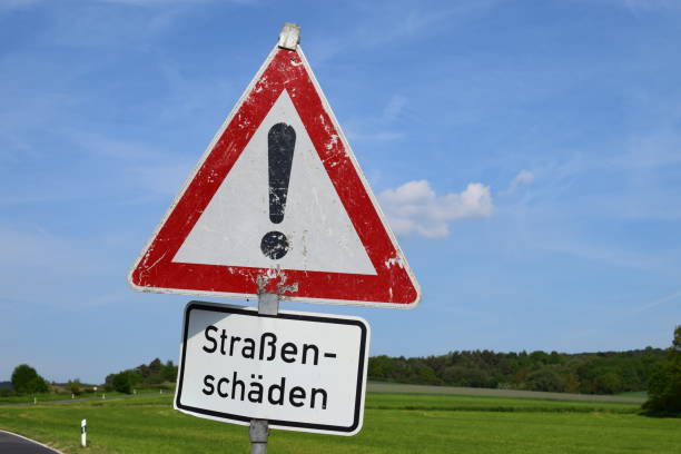 istock road damage warning sign, with an old damaged sign 1151399586
