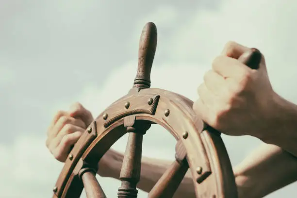 Photo of Steering hand wheel ship on sky background
