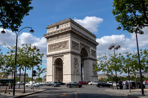 Paris, France - May 16, 2019 : The Arc de Triomphe de l'Etoile famous monument, standing at Place Charles de Gaulle, overlooking the Champs Elysees, iconic triumphal arch built to Napoleon victories