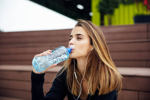 istock Young beautiful women resting and drinking water after doing exercises 1151402623