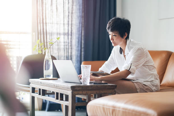 istock Asian female freelancer typing on laptop while working at home 1151404553