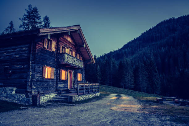 Rustic wooden farm hut in the night. European alps, Austria