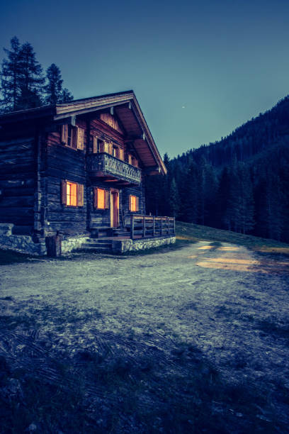 istock Holiday in the alps: Rustic wooden farm hut in the night. 1151409622