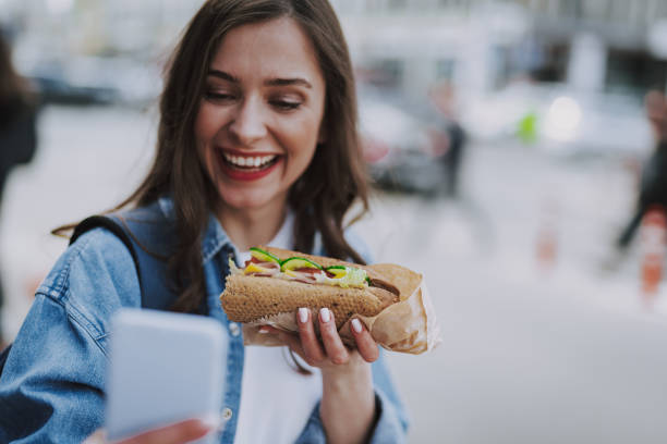 istock Joyful female making selfie with hot dog 1151411409