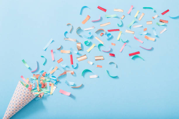 istock birthday hat with confetti on paper background 1151415894