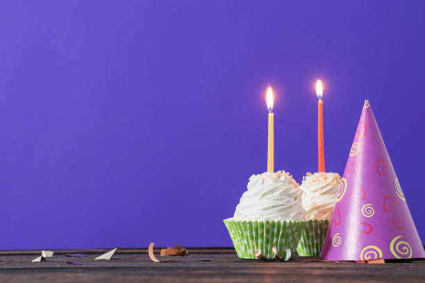 istock birthday cupcakes on violet background 1151415907