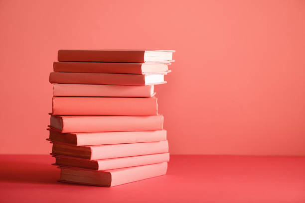 istock stack of books on living coral background 1151417870